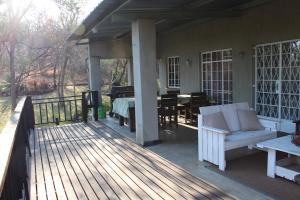 a porch of a house with a table and chairs at Tucked-Away 1&2 Bedroom Houses in Nelspruit