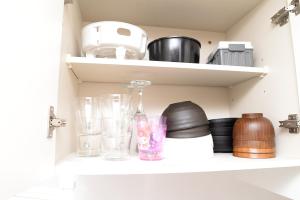 un estante con gafas y otros artículos. en ACT Residence No.1, en Tokio
