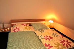 a bedroom with two beds with pillows and a lamp at Sonnenschein 29 - Großenbrode in Grossenbrode +14 photos