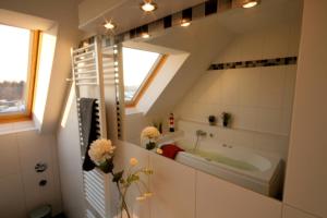 a bathroom with a bath tub and a sink at Sonnenschein 29 - Großenbrode in Grossenbrode