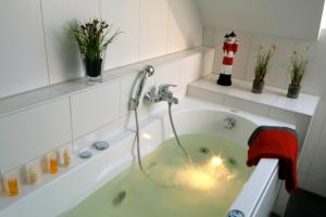 a bathroom with a bath tub with a faucet at Sonnenschein 29 - Großenbrode in Grossenbrode