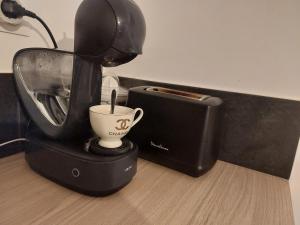a coffee machine with a cup on top of it at Maison proche Fatima batalha in Reguengo do Fetal