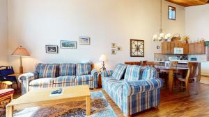a living room with two couches and a table at Meadow Ridge #28 condo in Mammoth Lakes