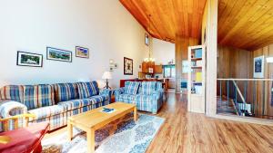a living room with a couch and a table at Meadow Ridge #28 condo in Mammoth Lakes