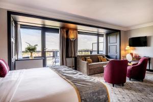 a hotel room with a large bed and a living room at Hotel Barsey by Warwick in Brussels