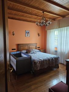 a bedroom with a bed and a chandelier at Vicia in O Vicedo