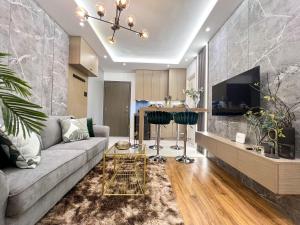 a living room with a couch and a table at Staycation at Camella Manors Verdant Palawan in Puerto Princesa City