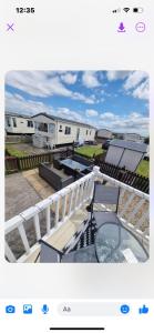 a view of an rv park with a table and a balcony at 163 Holiday Resort Unity Brean sands Pet friendly in Berrow