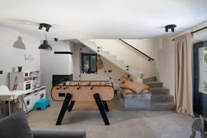 a living room with a pool table and stairs at Villa Stanza Campitelli for up to 21 people in Central Istria with private pool and pet friendly in Bale