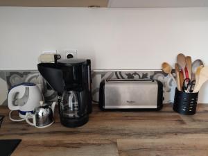 a kitchen counter with a coffee maker and a toaster at Gîte de la Rose in Saint-Vincent