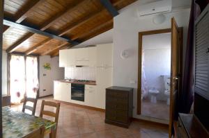 a kitchen with white cabinets and a table and a sink at Via Toscana House in Parma