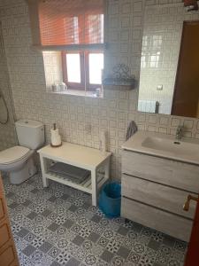 a bathroom with a sink and a toilet at Casa Rural MONTE ROBLO in Salamón +53 photos