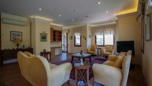 a large living room with chairs and a fireplace at Selimiye Meltem's in Marmaris