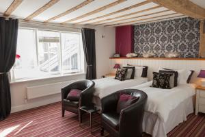 two beds in a room with two chairs and a window at Haydens in Rye +34 photos