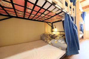Uma cama ou camas num quarto em 湯と風の宿 恵比寿