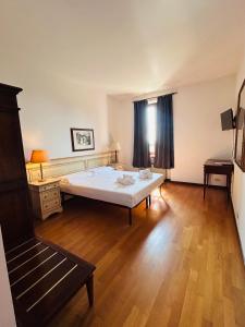 ein Schlafzimmer mit einem weißen Bett und einem Holzboden in der Unterkunft MH Hotel Merica in Sommacampagna + 41 Fotos