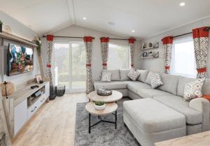 a living room with a couch and a table at Ingoldale Holiday Park in Ingoldmells