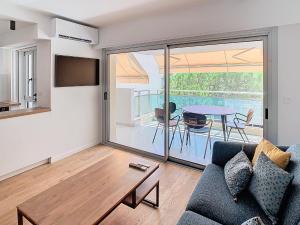a living room with a couch and a table at Appartements de Standing Cannes Centre in Cannes