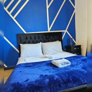 a bed with a blue blanket and white pillows at Sapphire Hotel Blackpool in Blackpool +7 photos