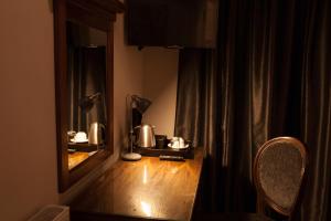 a dimly lit room with a wooden table and a lamp at Inglewood House and Spa in Alloa