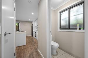a bathroom with a toilet and a sink and a window at Sovereign Hill Close -private, peaceful, modern in Ballarat +18 photos