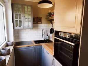 a kitchen with a sink and a stove top oven at Wohnung mit direktem Seeblick in Möhnesee