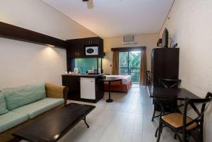 a living room with a couch and a table and a kitchen at Microtel by Wyndham Boracay in Boracay