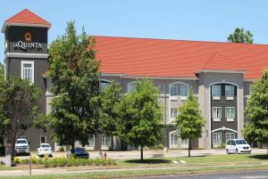 a hotel building with a red roof at La Quinta by Wyndham Huntsville Airport Madison in Madison