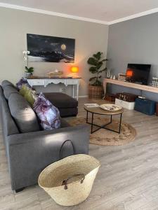 ein Wohnzimmer mit Sofa und Tisch in der Unterkunft Lovely Family Home in Pecanwood Golf Estate in Kosmos