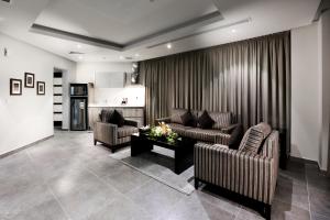 a living room with two couches and a table at Aswar Al olaya for serviced Apartments in Al Khobar