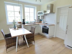 a kitchen with a table and chairs in a kitchen at Haus Nordlicht in Horn-Bad Meinberg
