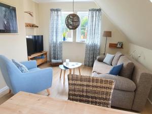 a living room with a couch and a tv at Haus Nordlicht in Horn-Bad Meinberg