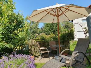 a patio with a table and chairs and an umbrella at Haus Nordlicht in Horn-Bad Meinberg +12 photos