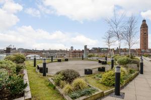 a park with benches and a view of a city at Native Victoria in London