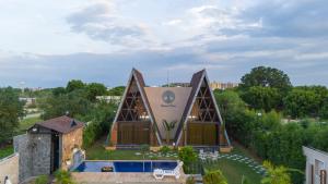 an aerial view of a building with a pool at ELIVAAS 4 BHK Pvt Pool & Party Hall - Oakwood Cottages in Jaipur +68 photos