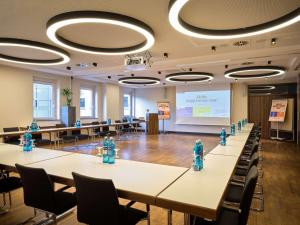 a conference room with tables with blue fire hydrants at Flemings Selection Hotel Frankfurt-City in Frankfurt