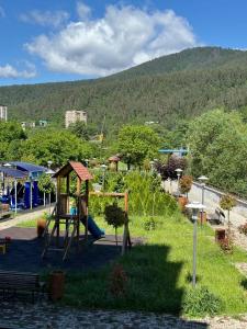 a park with a playground with a slide at Svani in Borjomi