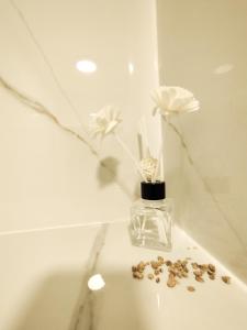 a vase with flowers in it on a table at Cozy A Noko Apartment in Murava