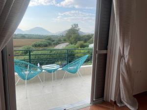a balcony with chairs and a view of mountains at Anastasias apartments in Sarandë