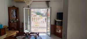 a living room with a glass door to a patio at CHRYSA' S House in Volos