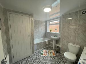 a bathroom with a toilet and a sink at Imeary -3 Bdrm Sleeps 5 Contractor Accommodation in Westoe +8 photos