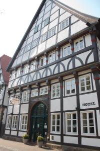 a black and white building with a hotel at Alt Warburg in Warburg