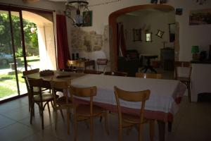 a dining room with a table and some chairs at Chez Germaine in Les Granges-Gontardes