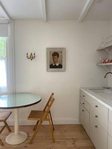 a table and chair in a kitchen with a picture on the wall at Captains Rest St Kilda West in Melbourne