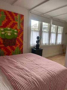 a bedroom with a bed with a painting on the wall at Captains Rest St Kilda West in Melbourne