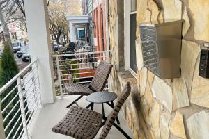 a balcony with two chairs and a table and a stove at Modern 4BR Columbia Heights Gem Walk 2 Metro & Shops in Washington +35 photos
