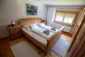 a bedroom with a large bed and a window at Frein Chalets - Kaltenbach in Frein