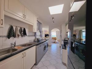 a large kitchen with a sink and a dishwasher at Boulevard 501 in Margate