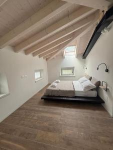a bedroom with a large bed in an attic at La Casa nella Vigna in Riva del Garda