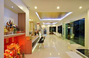 a lobby of a hospital with a counter and chairs at Tairada Boutique Hotel in Krabi town